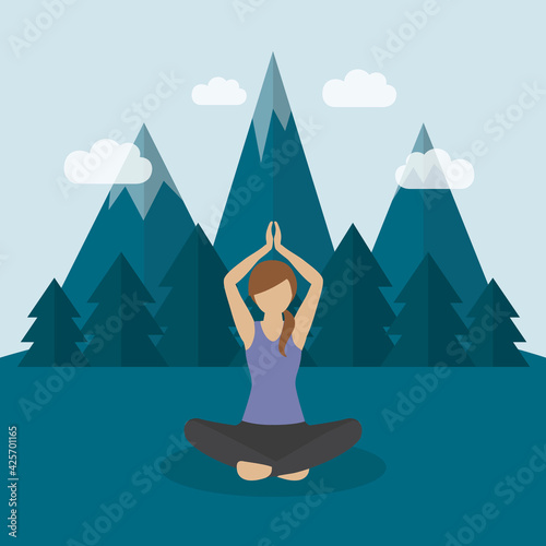 girl makes yoga on green mountain landscape