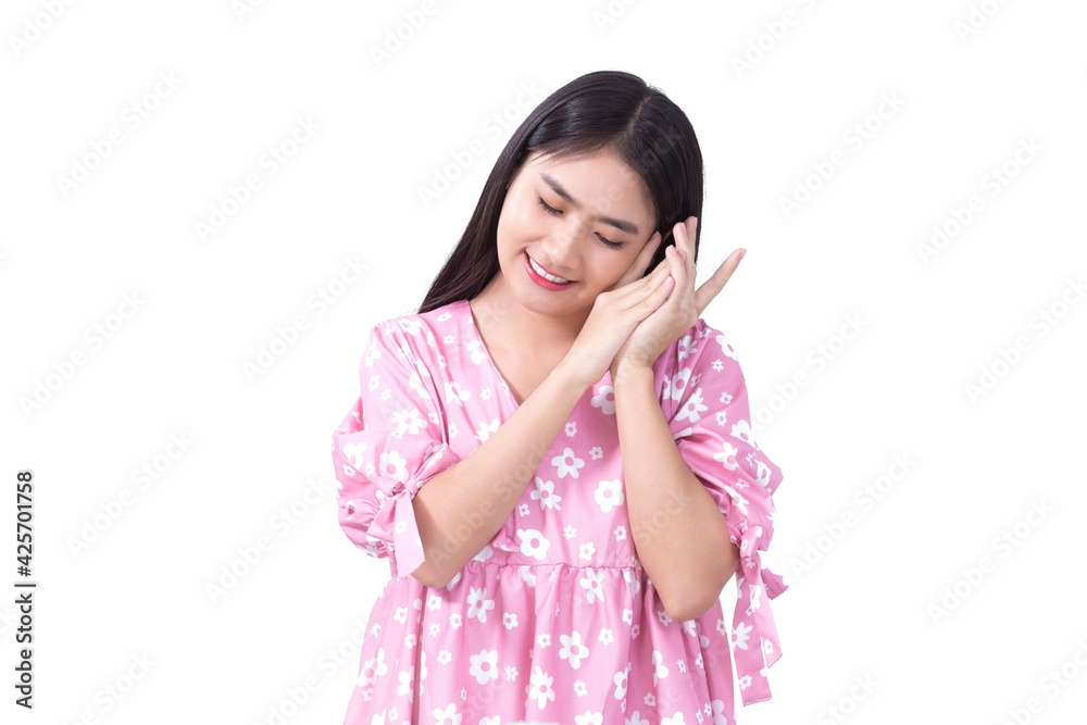 Portrait Asian beautiful girl in pink dress and black long hair. Her hands touch cheek, close her eyes and smile, show beautiful skin on white background. Portrait Asian beautiful girl in pink dress and black long hair. Her hands touch cheek, close her eyes and smile, show beautiful skin on white background.