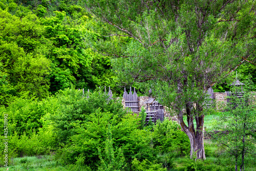 Ruins of an old abandoned fort, stone and wooden walls in nature