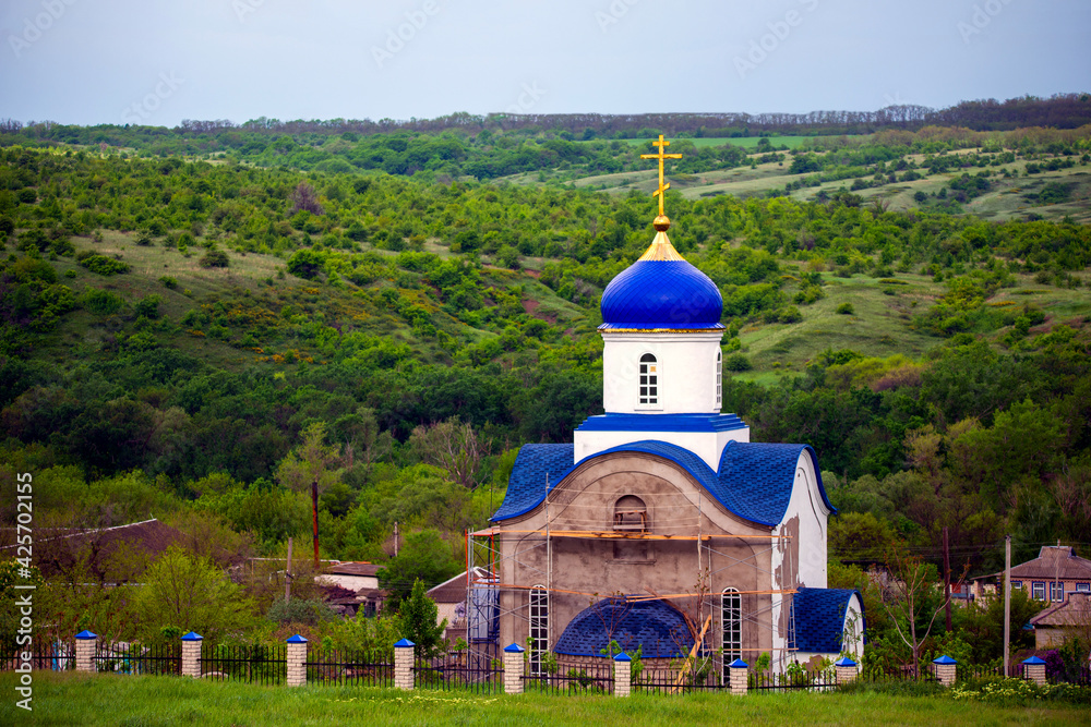 Blue dome of christian church with golden cross. Religious symbol of the Russian Orthodox Church