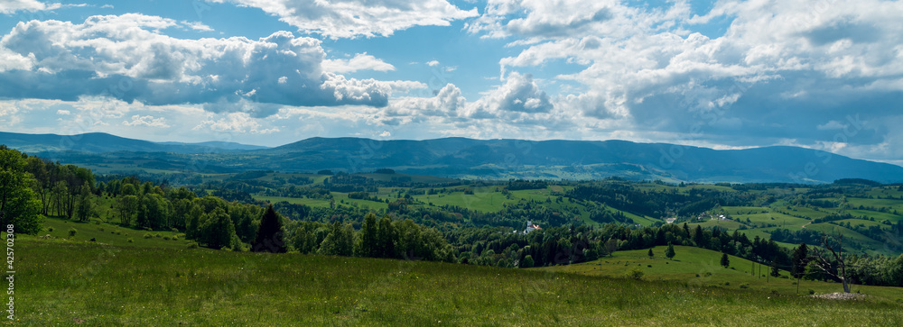Branna village with hills around from Alojzovske louky meadows in Jeseniky mountains in Czech republic