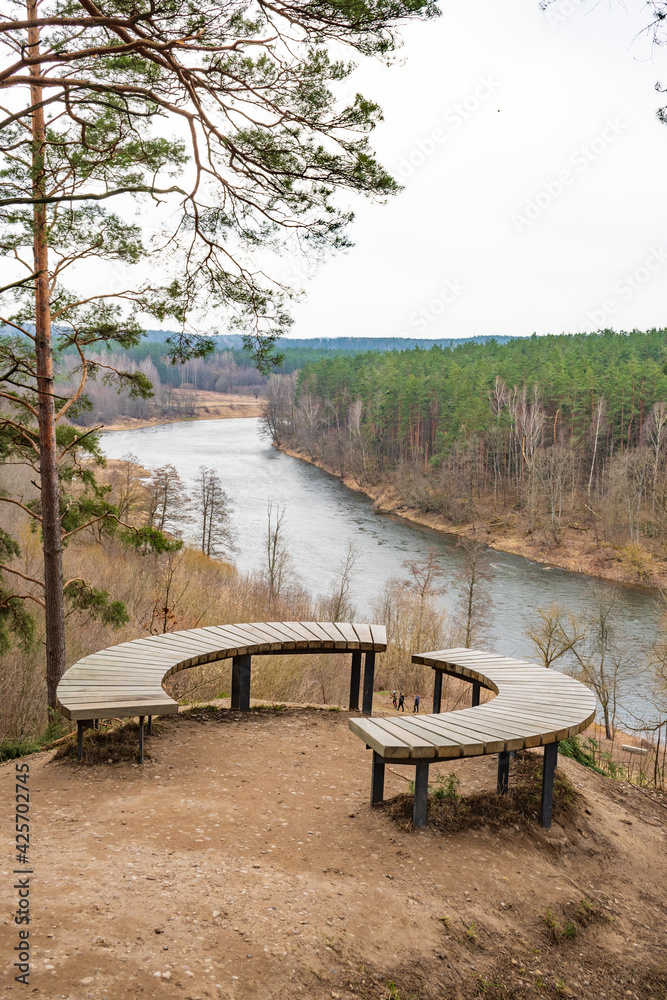 Beautiful panorama of valley with forest and river view from a hill with wooden circular bench, Neris Regional Park near Vilnius, Lithuania, vertical Beautiful panorama of valley with forest and river view from a hill with wooden circular bench, Neris Regional Park near Vilnius, Lithuania, vertical