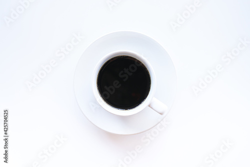 Top view of hot americano coffee in white coffee cup on white background, Minimal concept. 