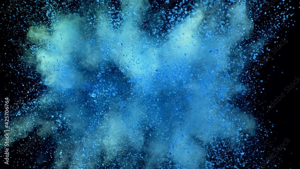 Super slow motion of coloured powder explosion isolated on black background.