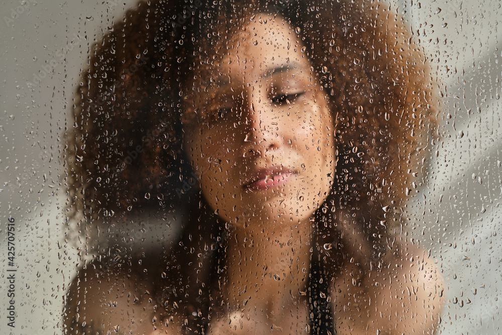 Defocused image of young female. Art portrait. Feminine beauty. Double exposure blur sensual pensive woman silhouette with steamed glass. Skincare wellness. Melancholy dream.