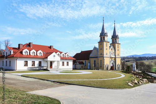 TRZCIANA, POLAND - MARCH 31, 2021: Big, luxurious residence of a priest and a church