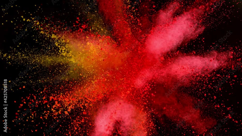 Super slow motion of coloured powder explosion isolated on black background.