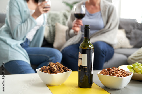 Bottle of wine and snack on the table photo