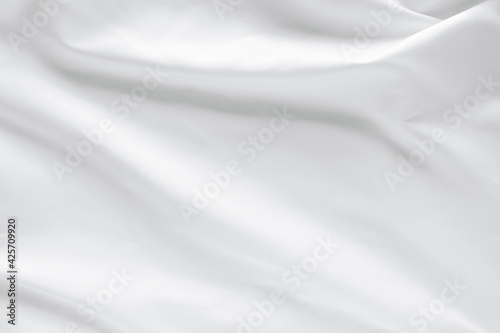 Abstract white fabric texture background. Cloth soft wave. Creases of satin, silk, and cotton.