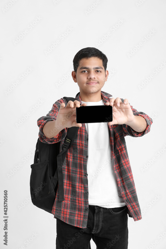 Indian college student showing mobile screen on white background. Indian college student showing mobile screen on white background.