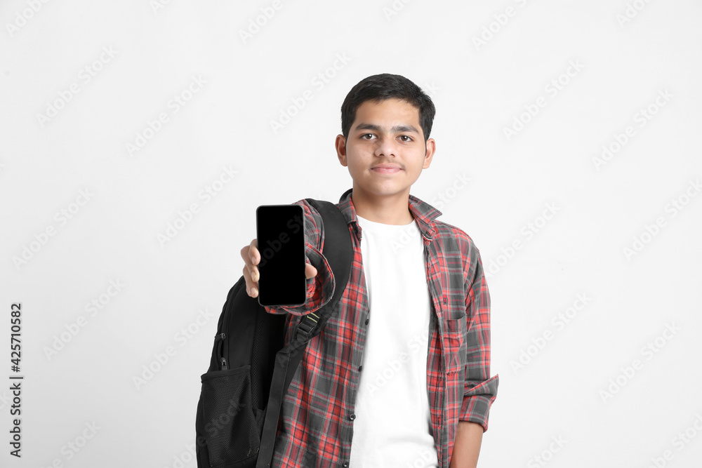Indian college student showing mobile screen on white background. Indian college student showing mobile screen on white background.