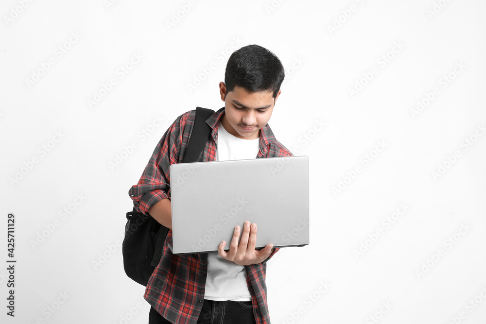 Indian college student using laptop on white background. Indian college student using laptop on white background.