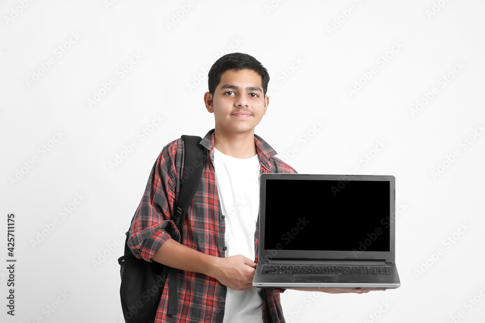 Indian college student showing laptop screen on white background. Indian college student showing laptop screen on white background.
