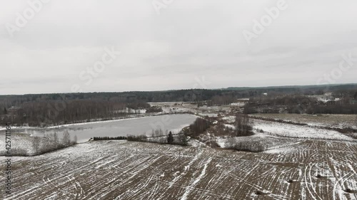 Countryside view with ploved agriculture fields and farm