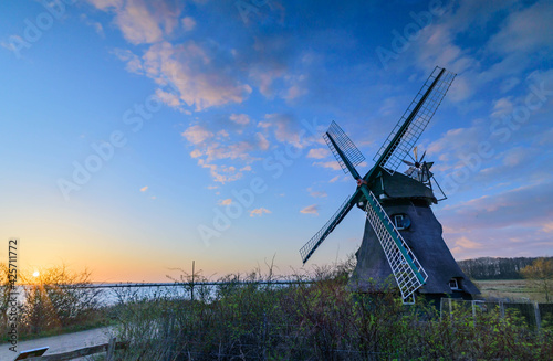 Sunset at the windmill Charlotte in Geltinger Birk, nature reserve Schleswig Holstein, Nieby, Germany. photo