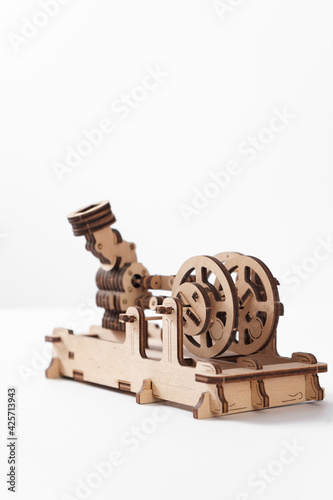 Model engine made of wood and plywood on a white background