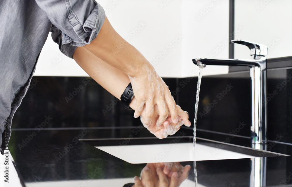 Naklejka premium close up of man during Washing hands with soap for corona virus prevention, hygiene to stop spreading coronavirus