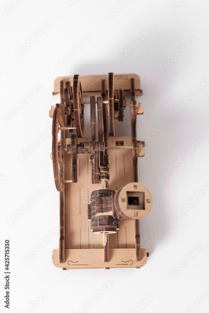 Model engine made of wood and plywood on a white background Model engine made of wood and plywood on a white background