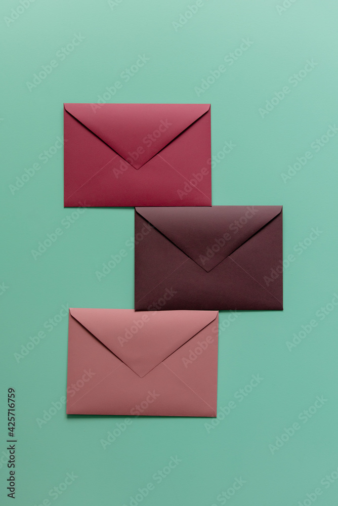 Three red envelopes on green background. Top view Three red envelopes on green background. Top view