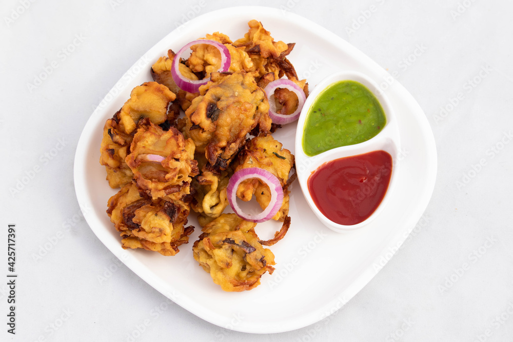 Crispy Indian Street Food With Various Names Like Onion Bhajji Pyaj Pakora Or Pakore Pyaaj Ke Pakode Or Pakoda Kanda Bhaji Pyaaz Bajji Served With Chutney And Sauce Is Tea Time Chaat Snacks