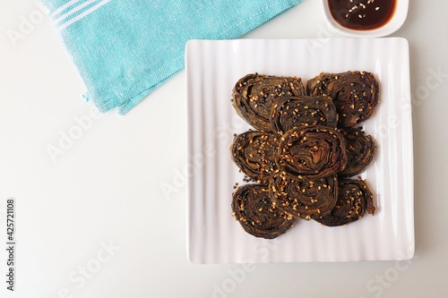 Alu Vadi, Patra, paatra, colocasia leaves roll, Patrode is a popular Indian healthy steamed snack. Garnished with sesame and mustard seeds. served with tamarind chutney. copy space. photo