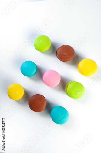 colored fresh macarons in studio on white background