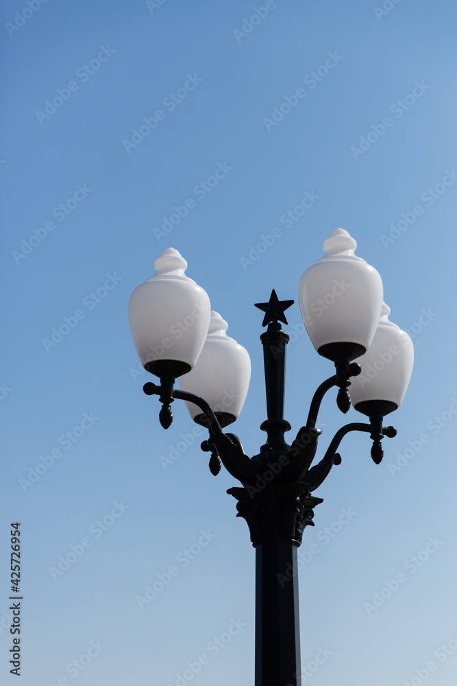beautiful street lamp with white plafonds on a blue background beautiful street lamp with white plafonds on a blue background