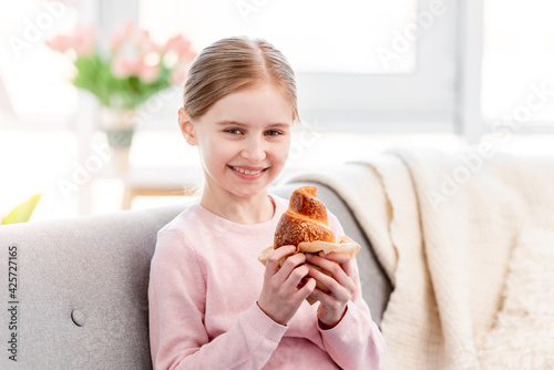 Little girl with croissant
