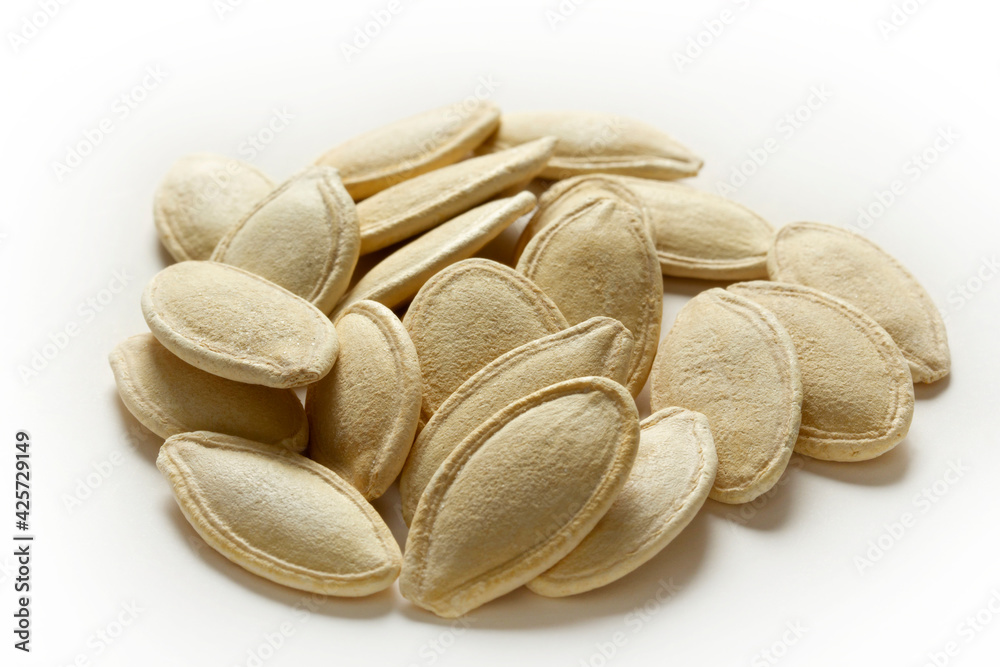 Pile of toasted Pumpkin seeds on white background Pile of toasted Pumpkin seeds on white background