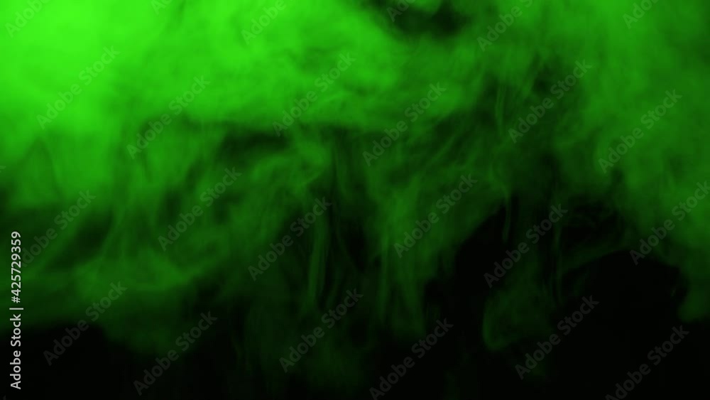 Dense green steam or smoke on a dark background. Dense green steam or smoke on a dark background.