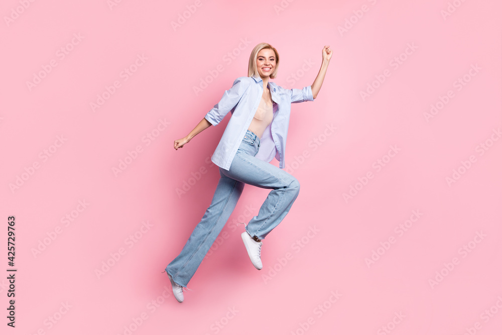 Full length profile portrait of charming cheerful person rush beaming smile isolated on pink color background Full length profile portrait of charming cheerful person rush beaming smile isolated on pink color background
