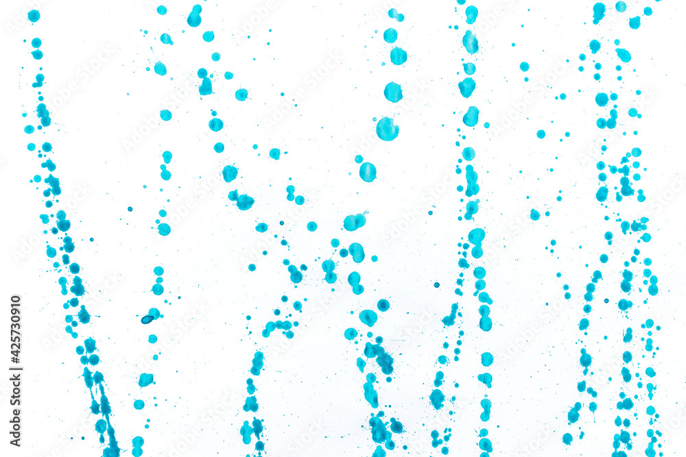 Abstract dots blue acrylic ink color splashes ink blots on white background.
