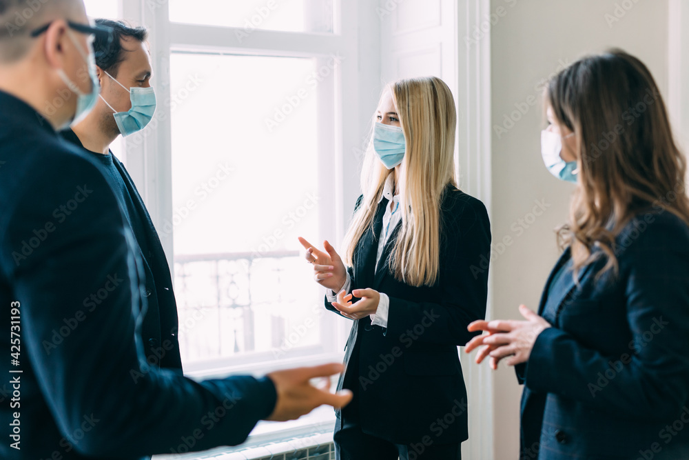 Business worker discuss and meeting while wearing medical mask as protection from corona virus. New normal office working. Group of multiethnic people in business reopen. flu prevent healthy