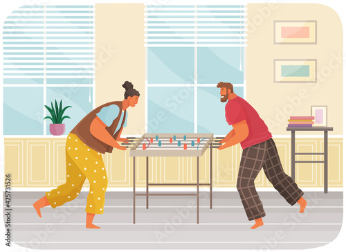 Cheerful couple with board game. Man and woman play table football together in room near stairs