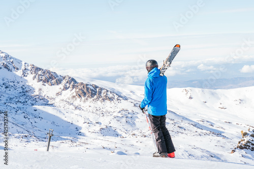 Ski. Skier. Skier walking on the snowy mountain. Skier walking in the snow. Snowy mountain. High mountain. Extreme sports. Sierra Nevada