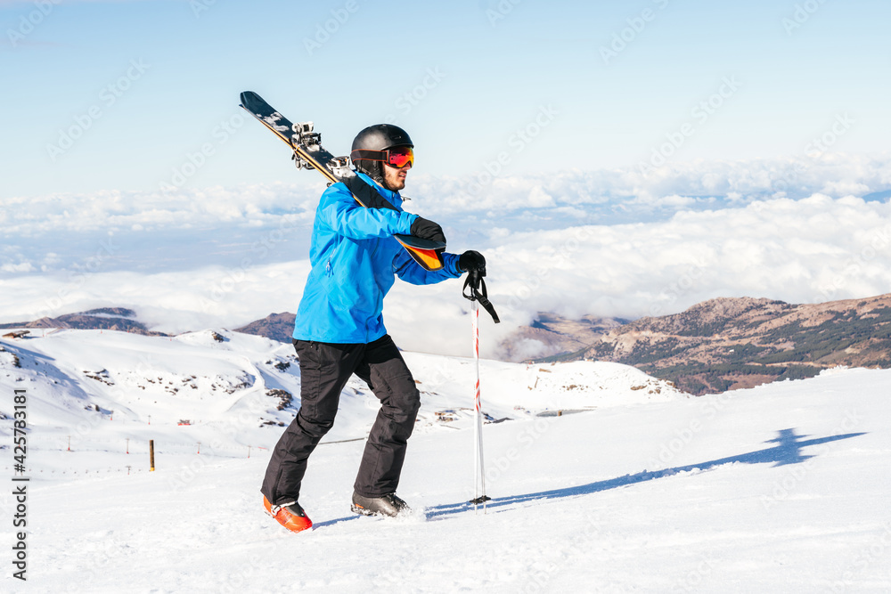 Ski. Skier. Skier walking on the snowy mountain. Skier walking in the snow. Sierra Nevada. Snowy mountain