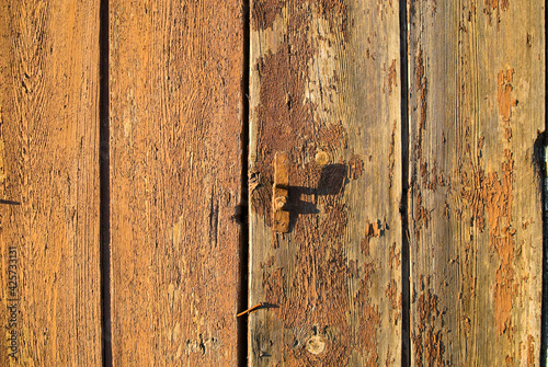 Old wall of wooden planks with paint cracked .