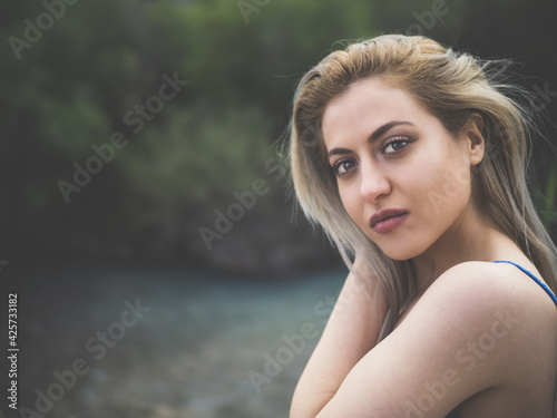portrait of a woman next to a river