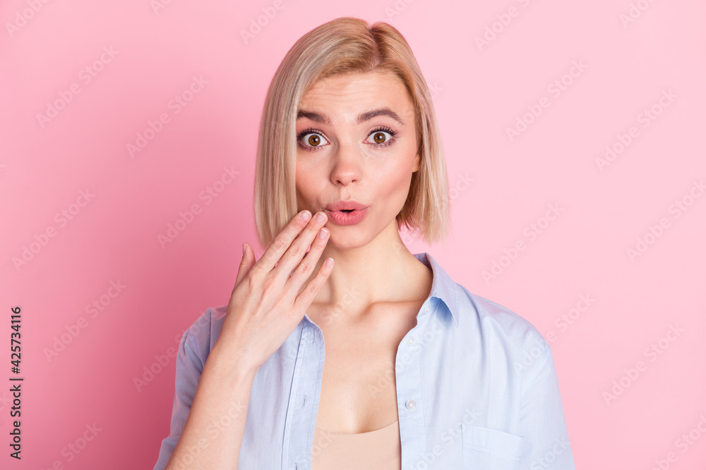 Photo of shocked amazed guilty young woman hold hand mouth tell secret isolated on pastel pink color background Photo of shocked amazed guilty young woman hold hand mouth tell secret isolated on pastel pink color background