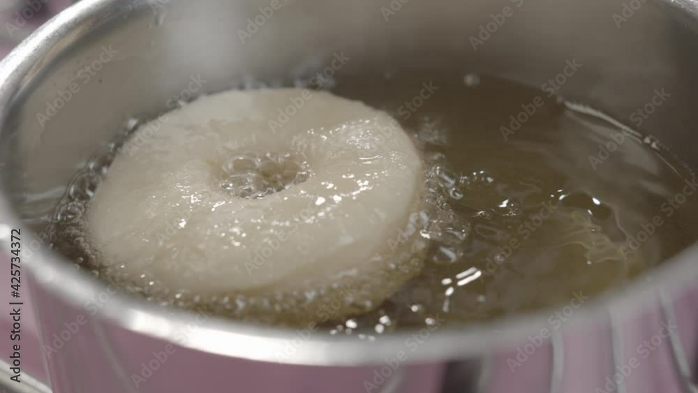 Process of frying donuts in a hot oil. Baking concept Process of frying donuts in a hot oil. Baking concept