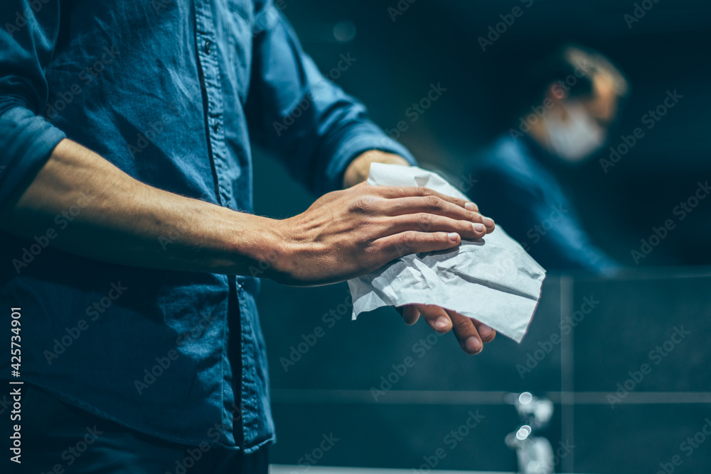 top view. a man carefully washes his hands in the bathroom