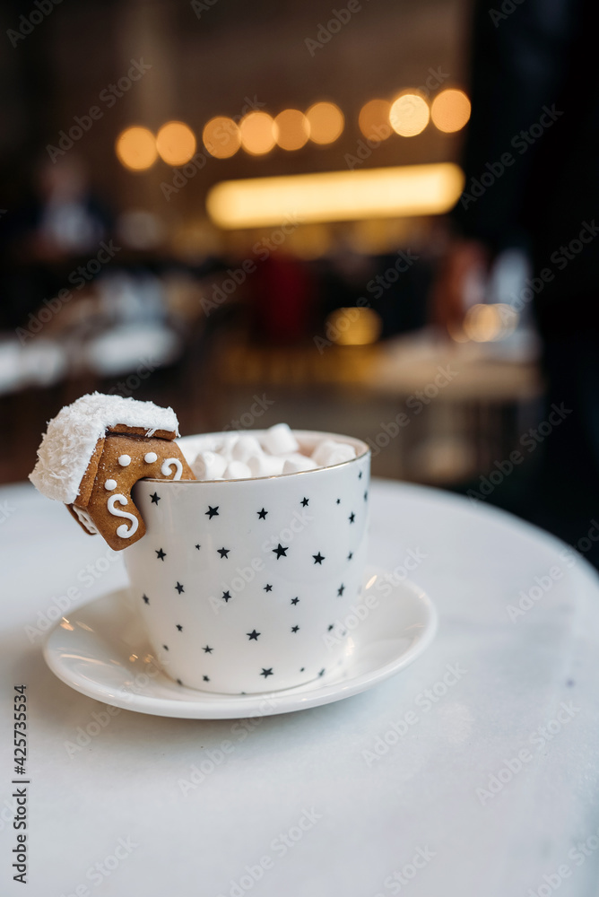 The mug with the christmas decorations and cookie on edge The mug with the christmas decorations and cookie on edge
