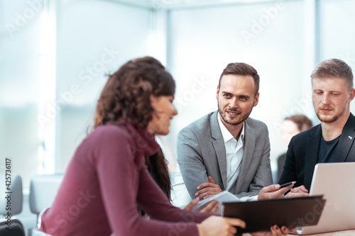 young employees discussing problems at a group meeting.