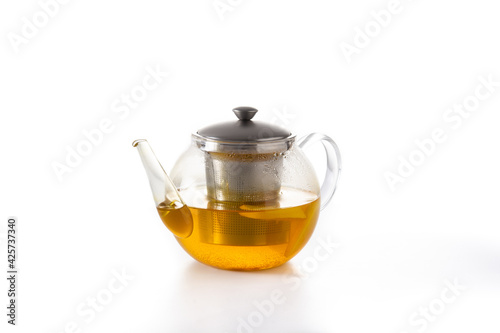 Teapot with ginger tea, lemon and honey isolated on white background