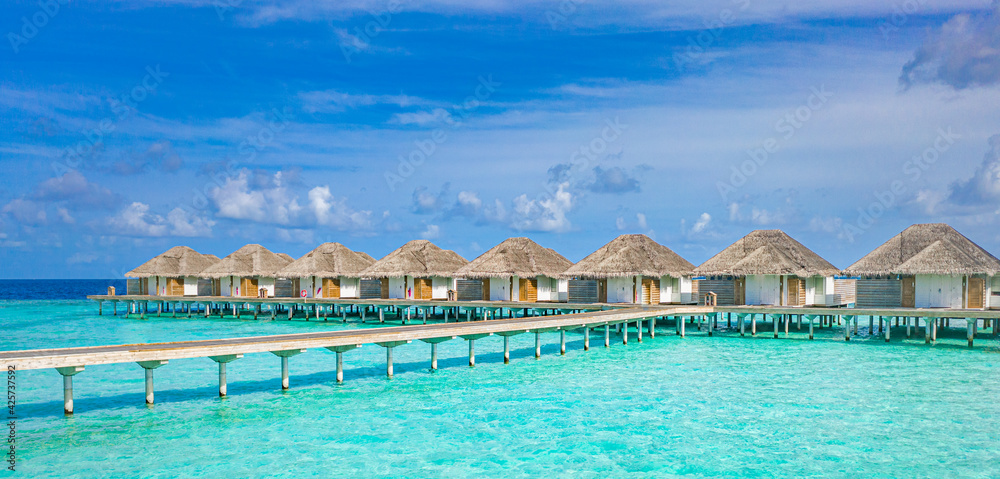 Travel landscape of Maldives beach. Tropical panorama, luxury water villa resort, wooden pier or jetty. Ocean lagoon, seaside. Luxury travel destination background for summer holiday vacation concept.