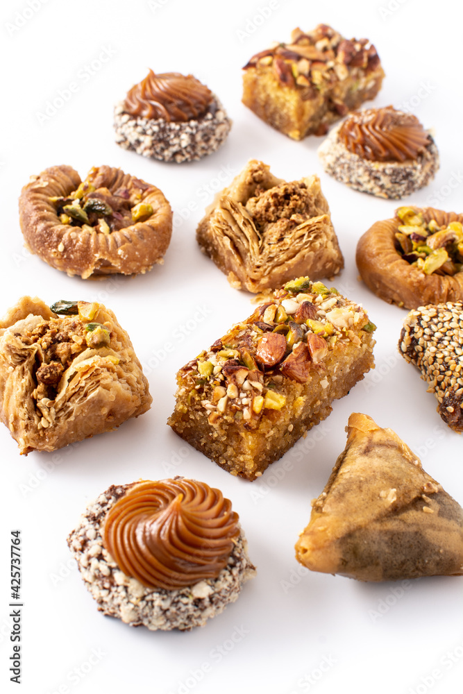 Assortment of Ramadan dessert baklava and dates isolated on white background	
