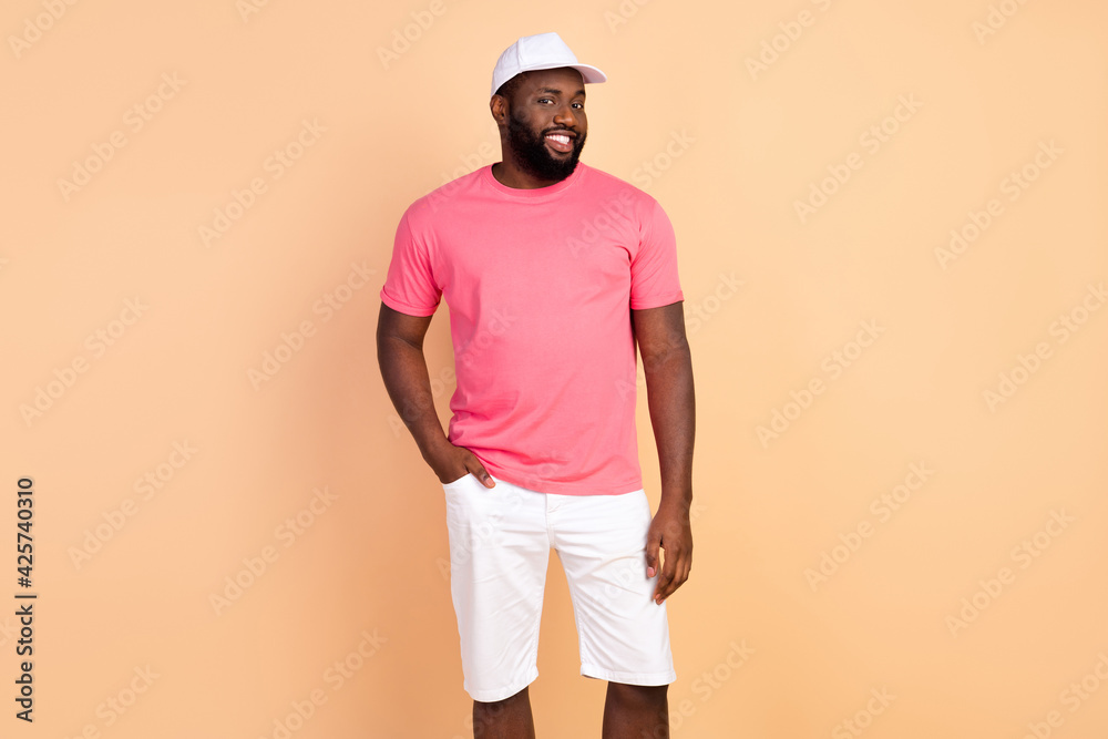 Photo portrait of man wearing casual clothes cap smiling isolated pastel beige color background