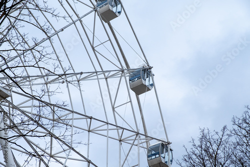 Ferris wheel on a background of a gray sky on a cloudy day.