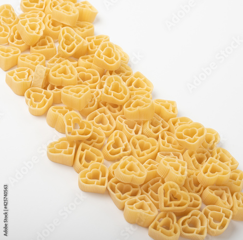 Raw Italian pasta fettuccine, amorini, paccheri, farfalle, spaghetti, fusilli, penne, conchiglie isolated on a white background. Top view