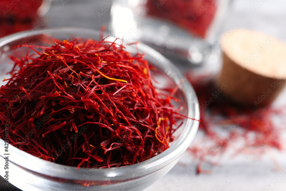 Fototapeta premium Dried saffron in glass bowl, closeup view